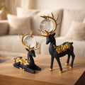 SET OF Two Black and Gold Floral Deer Sculptures with Crystal Orbs .
